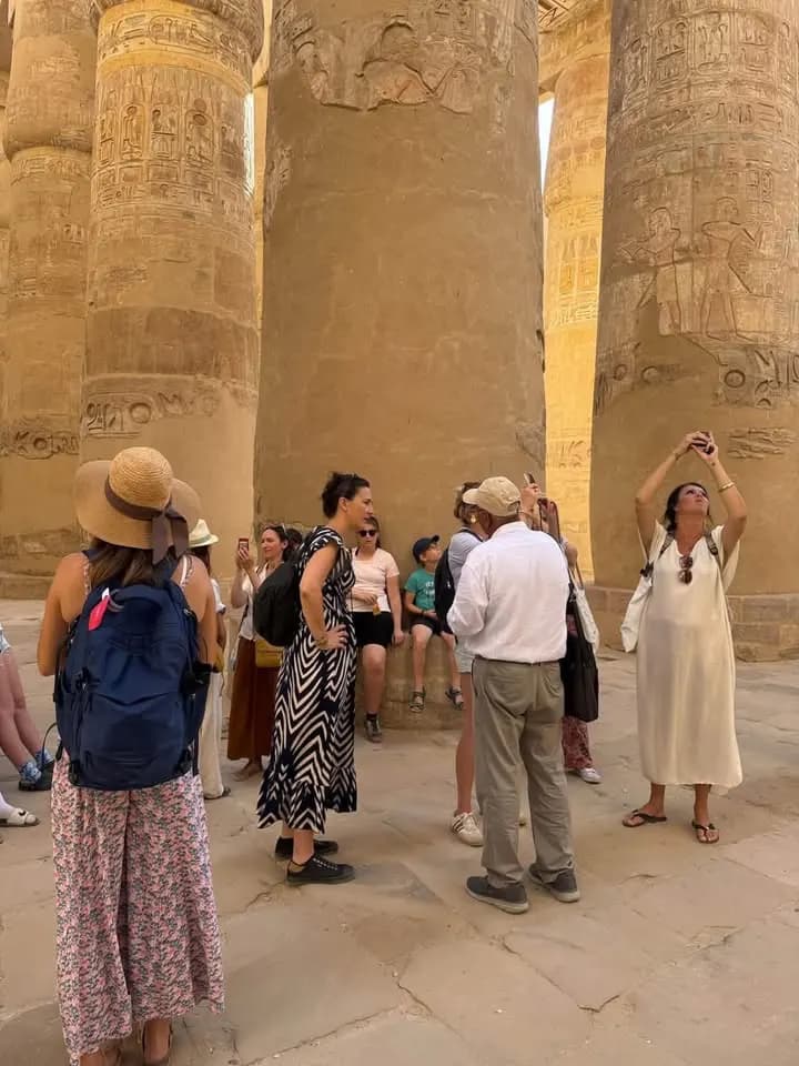 Tourists admiring the giant columns of the Great Hypostyle Hall at Karnak, Luxor